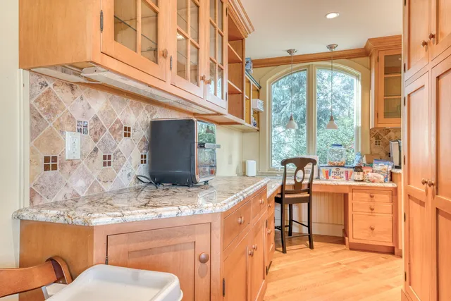 a kitchen with stainless steel appliances granite countertop a stove and a refrigerator
