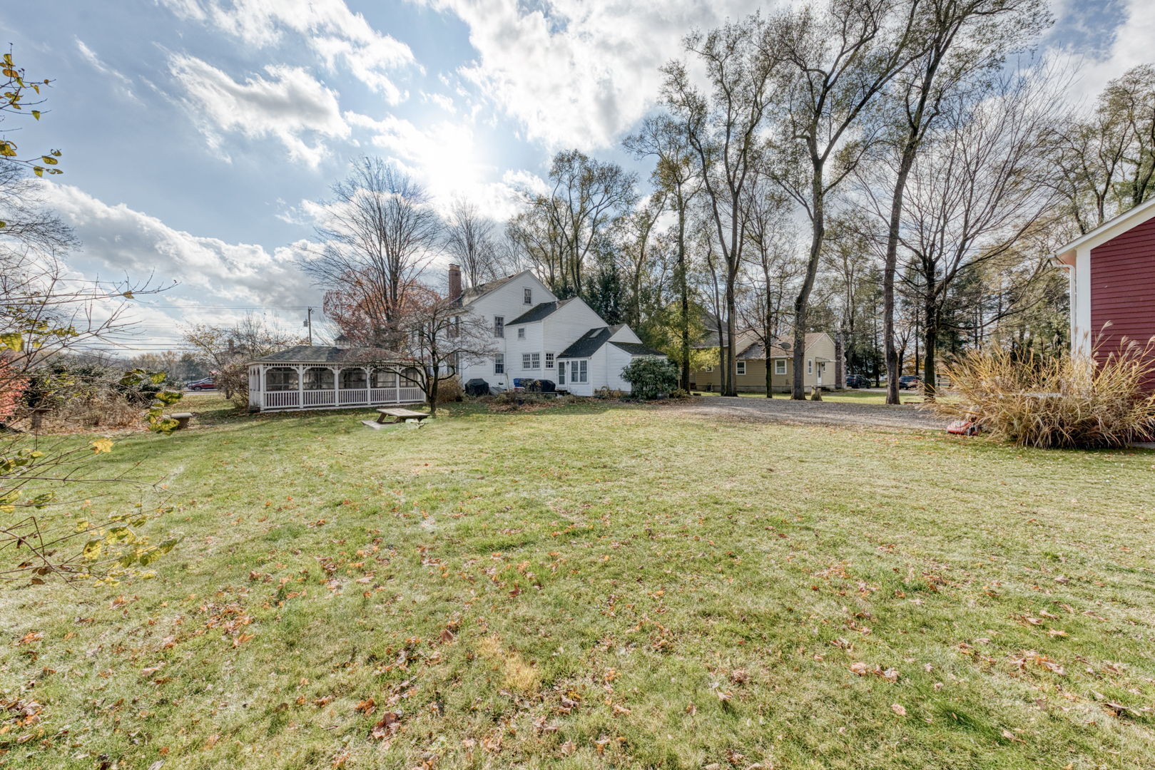 89 Maple Street Ellington, CT 06029 - Photo 38 of 40 a view of a field with a white house in the background