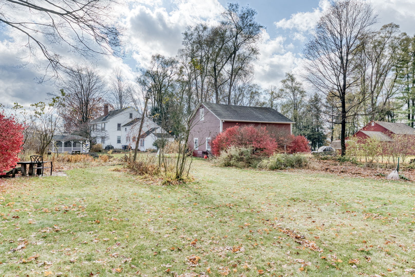 89 Maple Street Ellington, CT 06029 - Photo 4 of 40 a backyard of a house with lots of green space and fountain