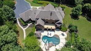 5675 Kennedy Road Suwanee, GA 30024 - Photo 1 of 1 an aerial view of a house with outdoor space