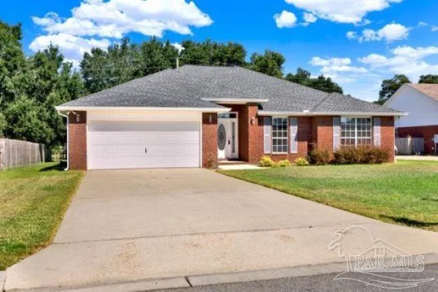 a view of a yard in front of a house with green space