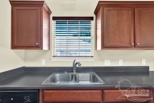 a living room with furniture and a lamp