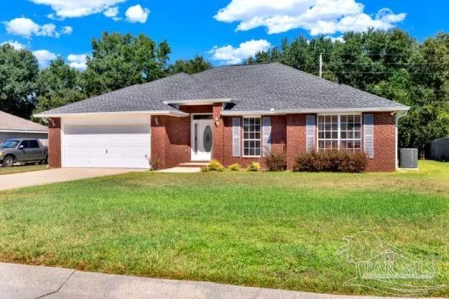 a front view of house with yard and green space