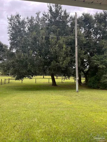 a view of a dining room with furniture a chandelier and wooden floor