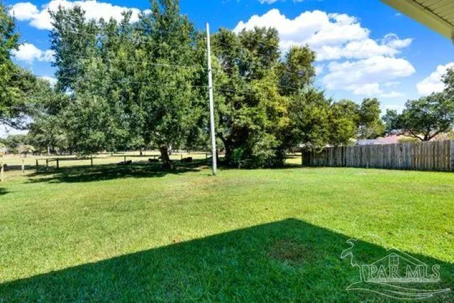 a dining room with furniture a chandelier and window