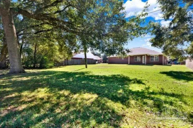 a view of a dining room with furniture a chandelier and wooden floor