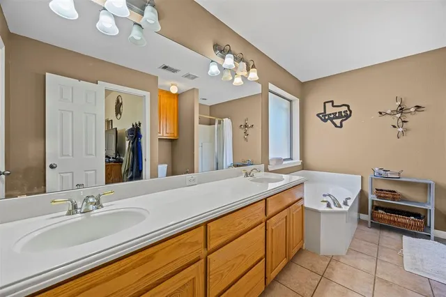 a spacious bathroom with a granite countertop sink a toilet a mirror and vanity