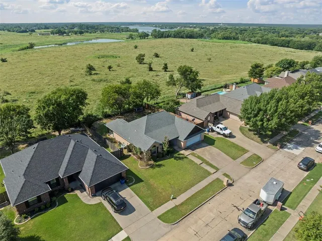 an aerial view of a house with outdoor space and lake view