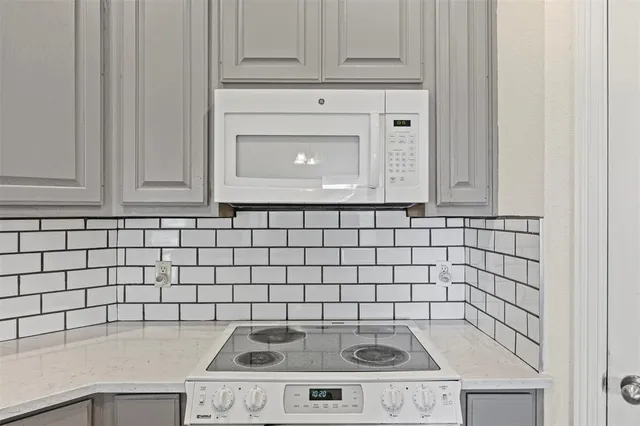 a stove top oven sitting inside of a kitchen