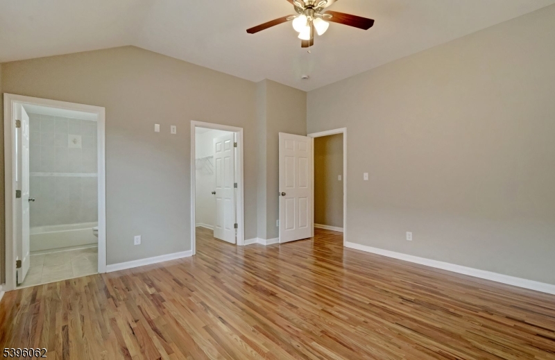 12 Edwin Street Carteret, NJ 07008 - Photo 11 of 20 an empty room with wooden floor and a ceiling fan