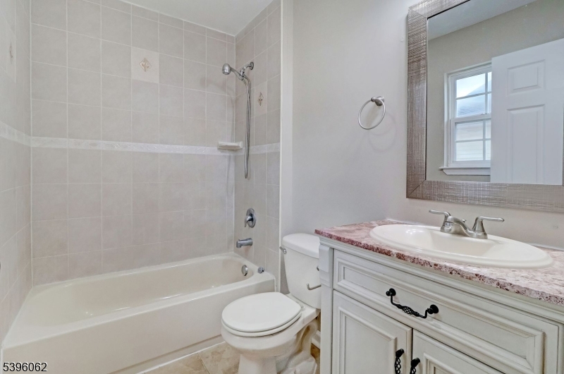 12 Edwin Street Carteret, NJ 07008 - Photo 13 of 20 a bathroom with a granite countertop toilet sink and mirror