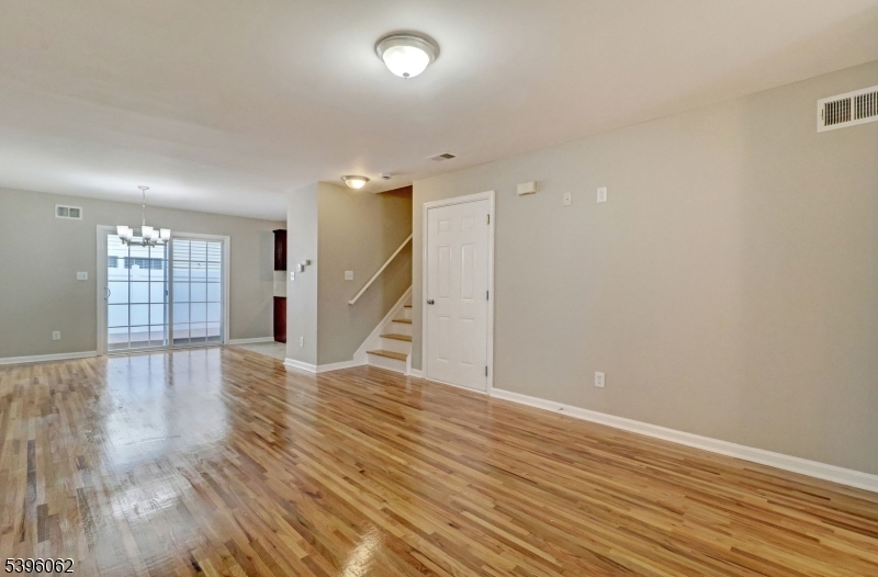 12 Edwin Street Carteret, NJ 07008 - Photo 6 of 20 a view of an empty room with wooden floor and a window