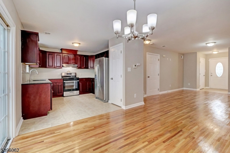 12 Edwin Street Carteret, NJ 07008 - Photo 9 of 20 a view of kitchen with wooden floor and chandelier