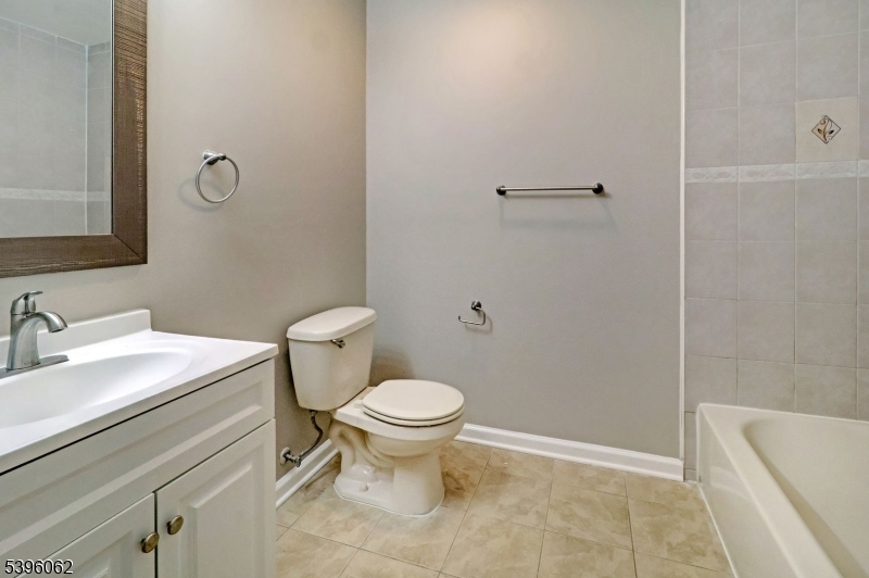 12 Edwin Street Carteret, NJ 07008 - Photo 10 of 20 a bathroom with a sink toilet and shower