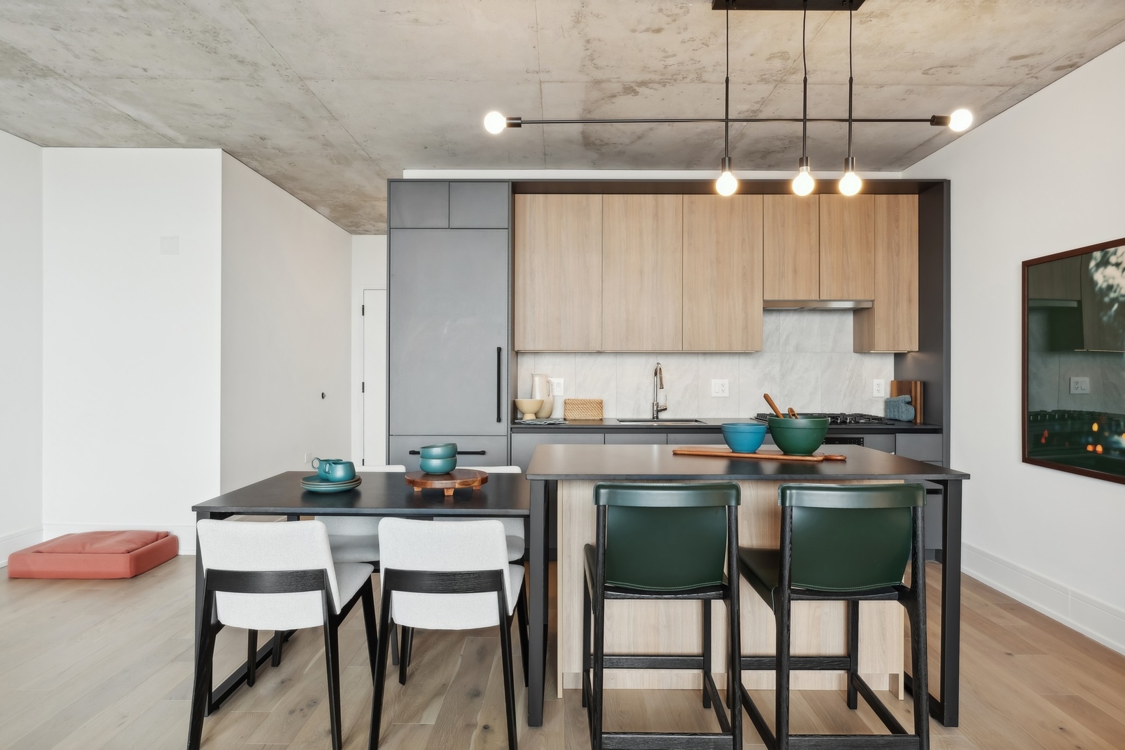 234 West Polk Street, Unit 2905 Chicago, IL 60607 - Photo 9 of 36 a kitchen with a table chairs refrigerator and cabinets
