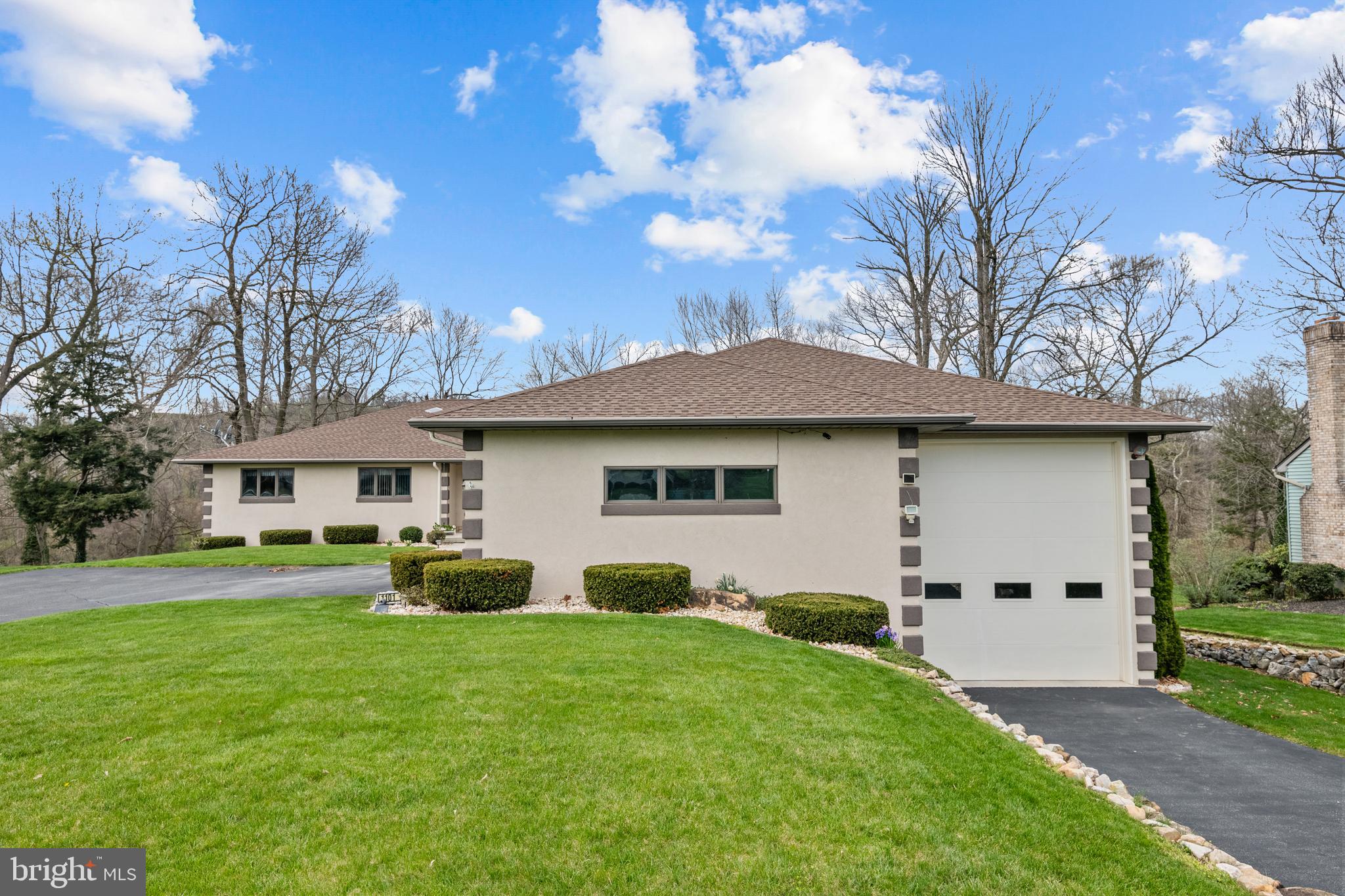 1101 Riverview Drive Reading, PA 19605 - Photo 64 of 67 a front view of a house with a garden and trees