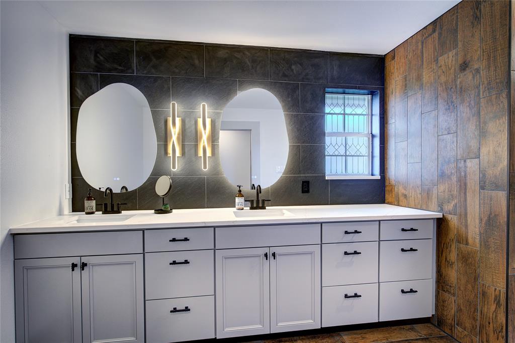 2027 Park Springs Road Sulphur Springs, TX 75482 - Photo 21 of 39 a bathroom with a double vanity sink and a mirror
