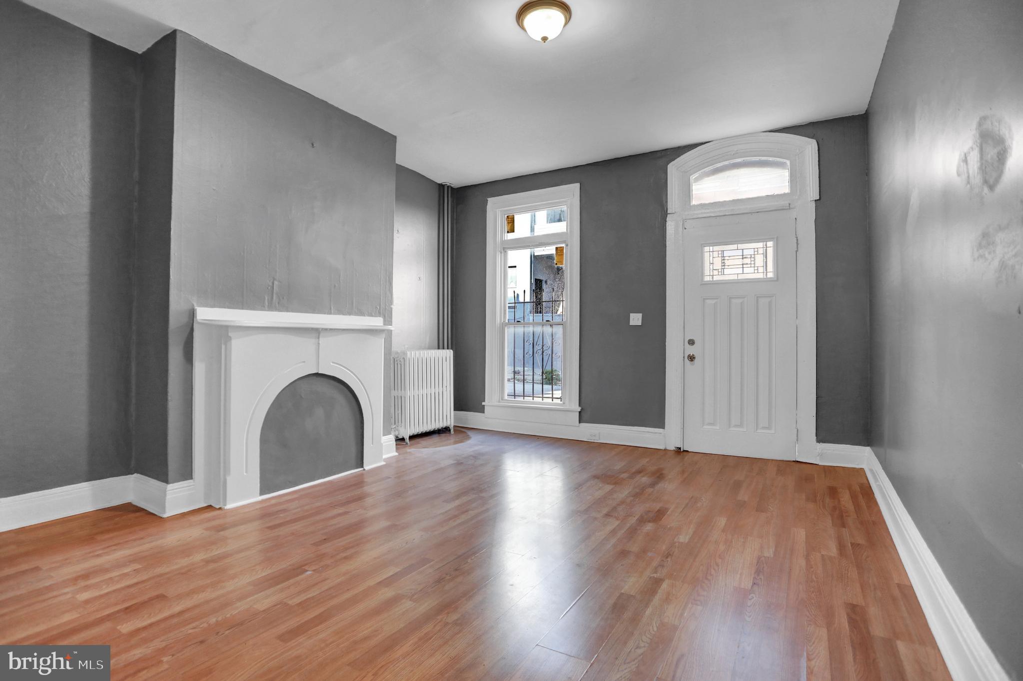957 Bennett Place Baltimore, MD 21223 - Photo 3 of 30 a view of an empty room with wooden floor and a window