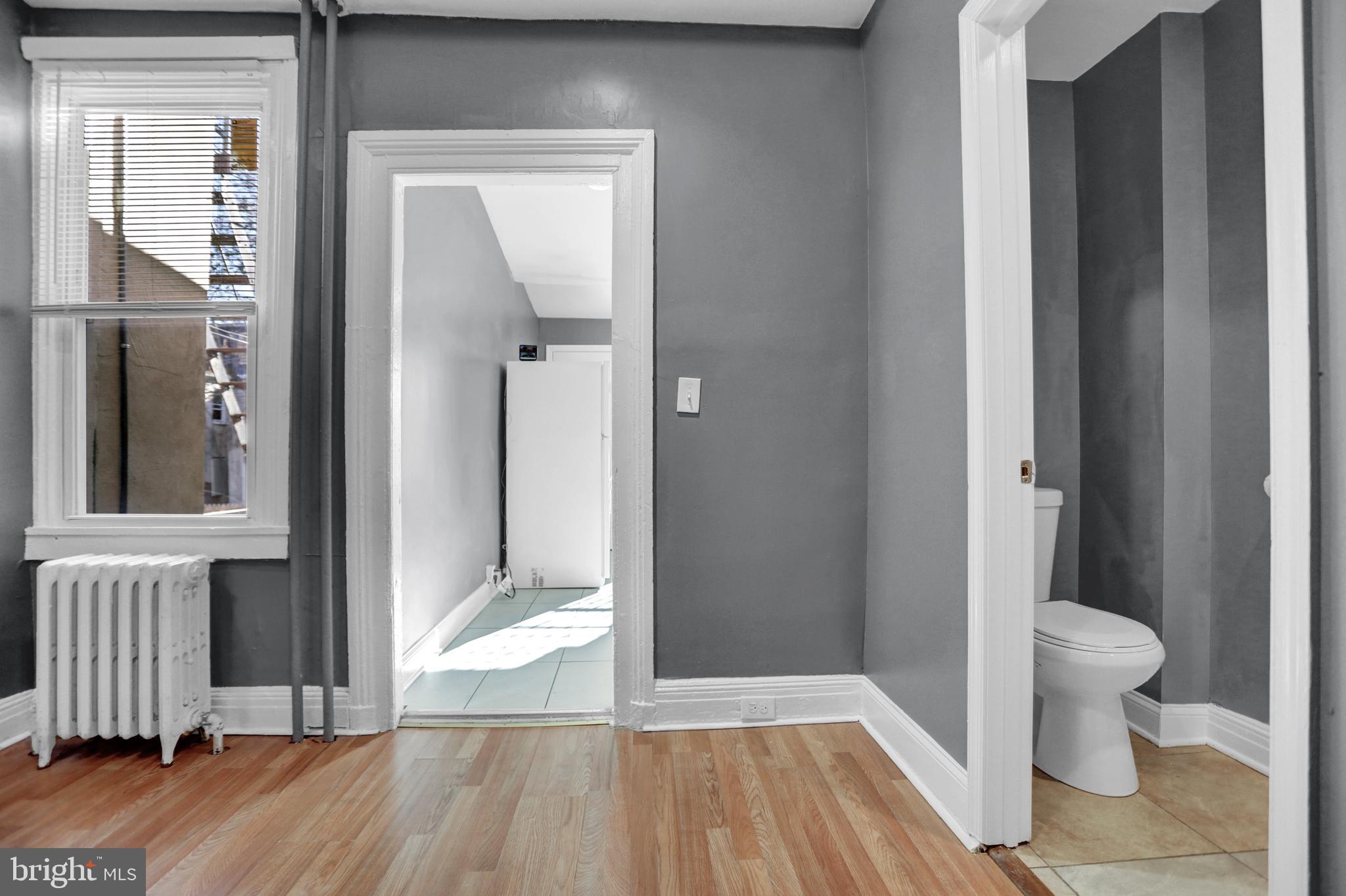 957 Bennett Place Baltimore, MD 21223 - Photo 7 of 30 a view of a room with wooden floor and door