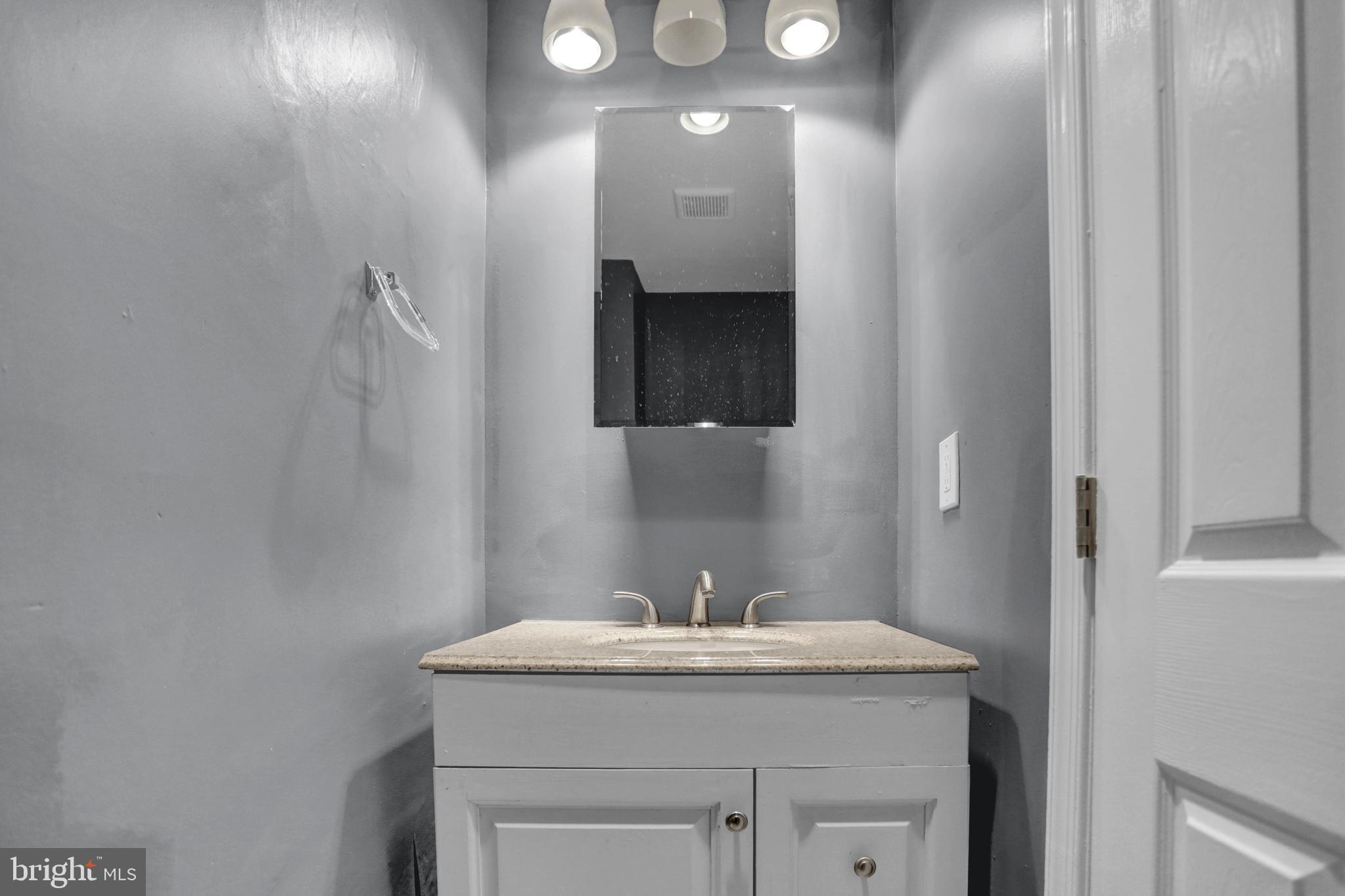 957 Bennett Place Baltimore, MD 21223 - Photo 8 of 30 a bathroom with a granite countertop sink and a mirror