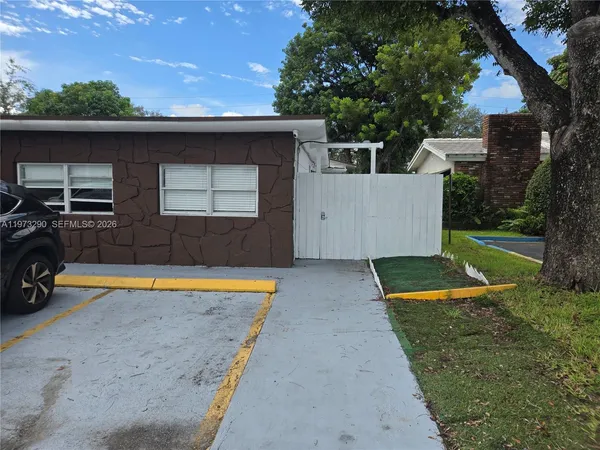a view of a backyard with a tub and trees in the background