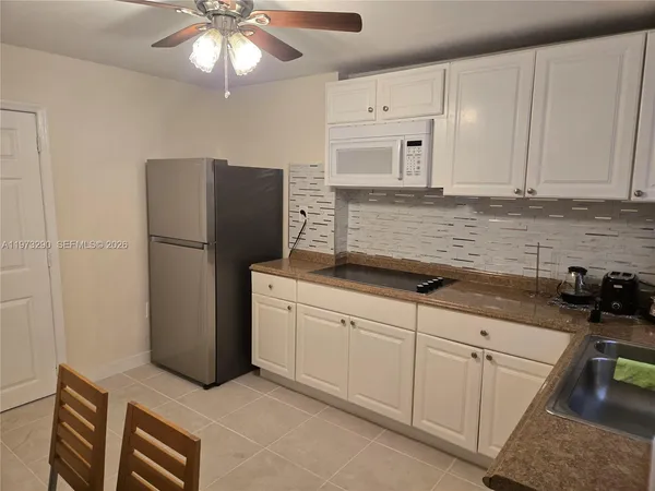 a kitchen with cabinets and stainless steel appliances