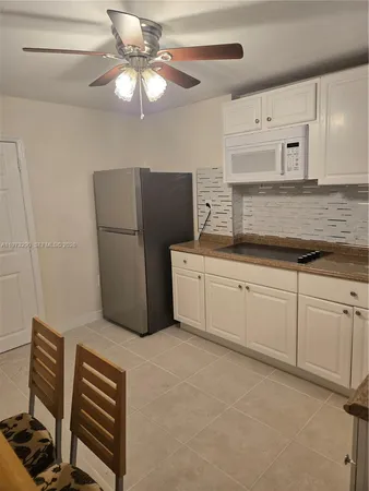 a kitchen with a refrigerator and a sink