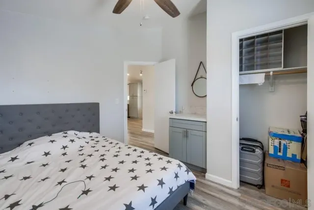 a bedroom with a bed and cabinets