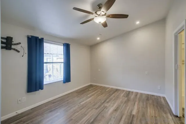 wooden floor in an empty room with a window