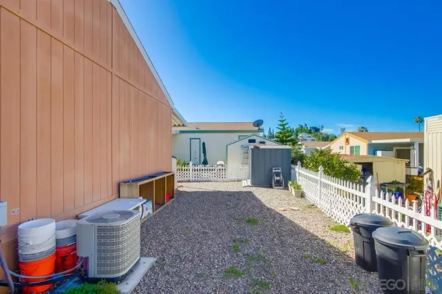 a view of a chairs and table in the backyard