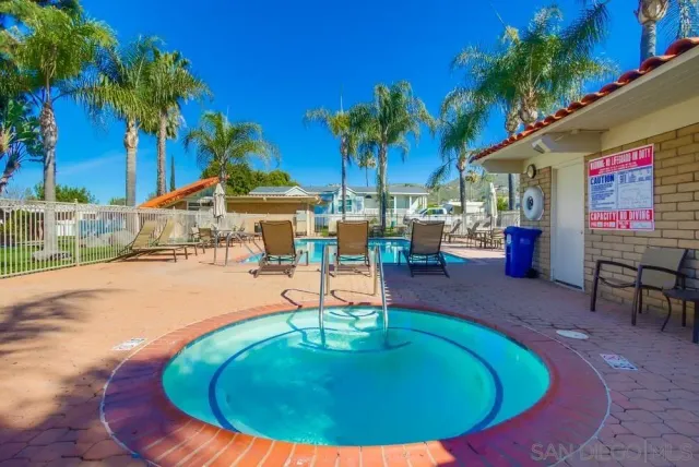 a swimming pool with outdoor seating
