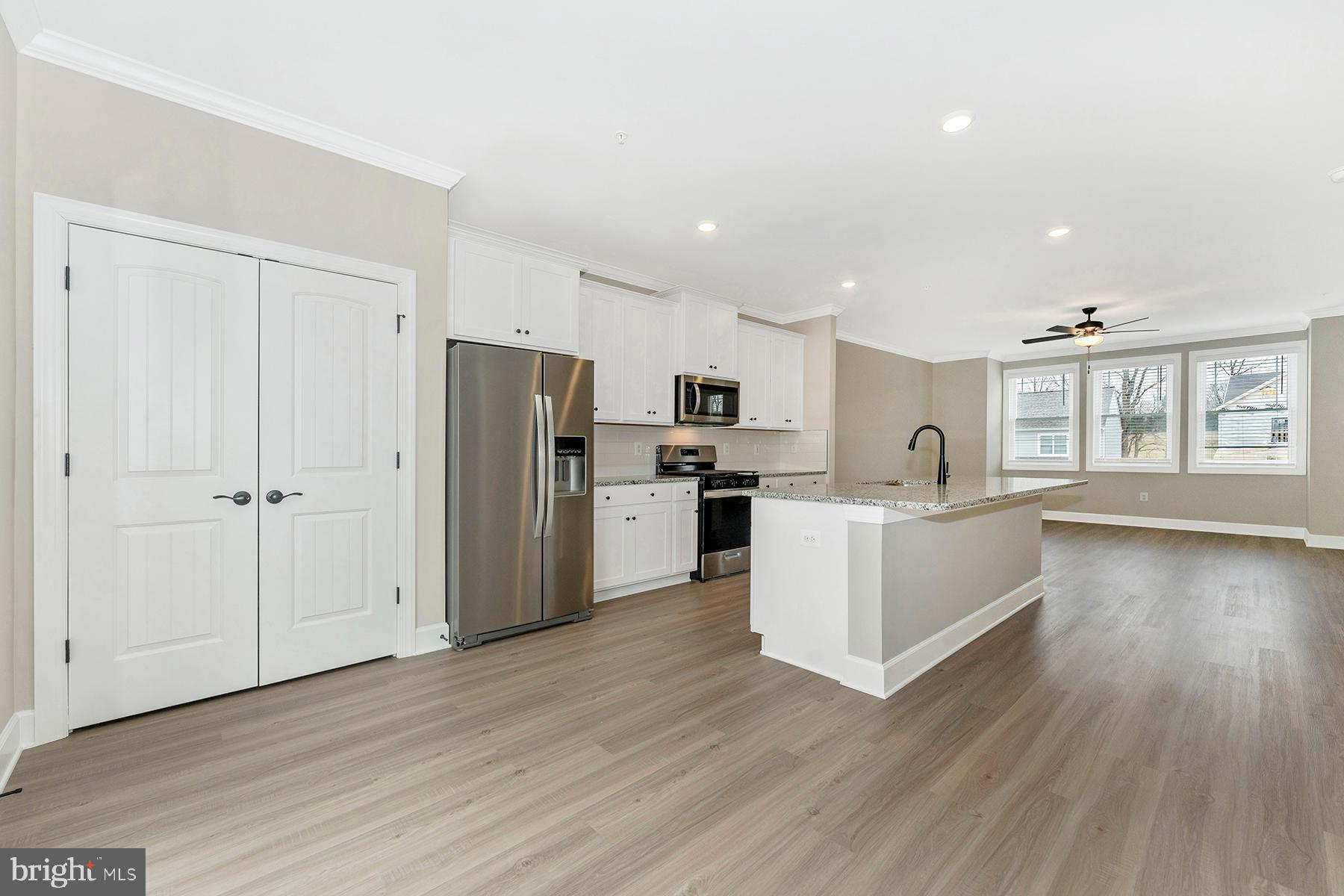 511 Iverson Road Waynesboro, PA 17268 - Photo 15 of 26 a large kitchen with a center island wooden floor stainless steel appliances and windows