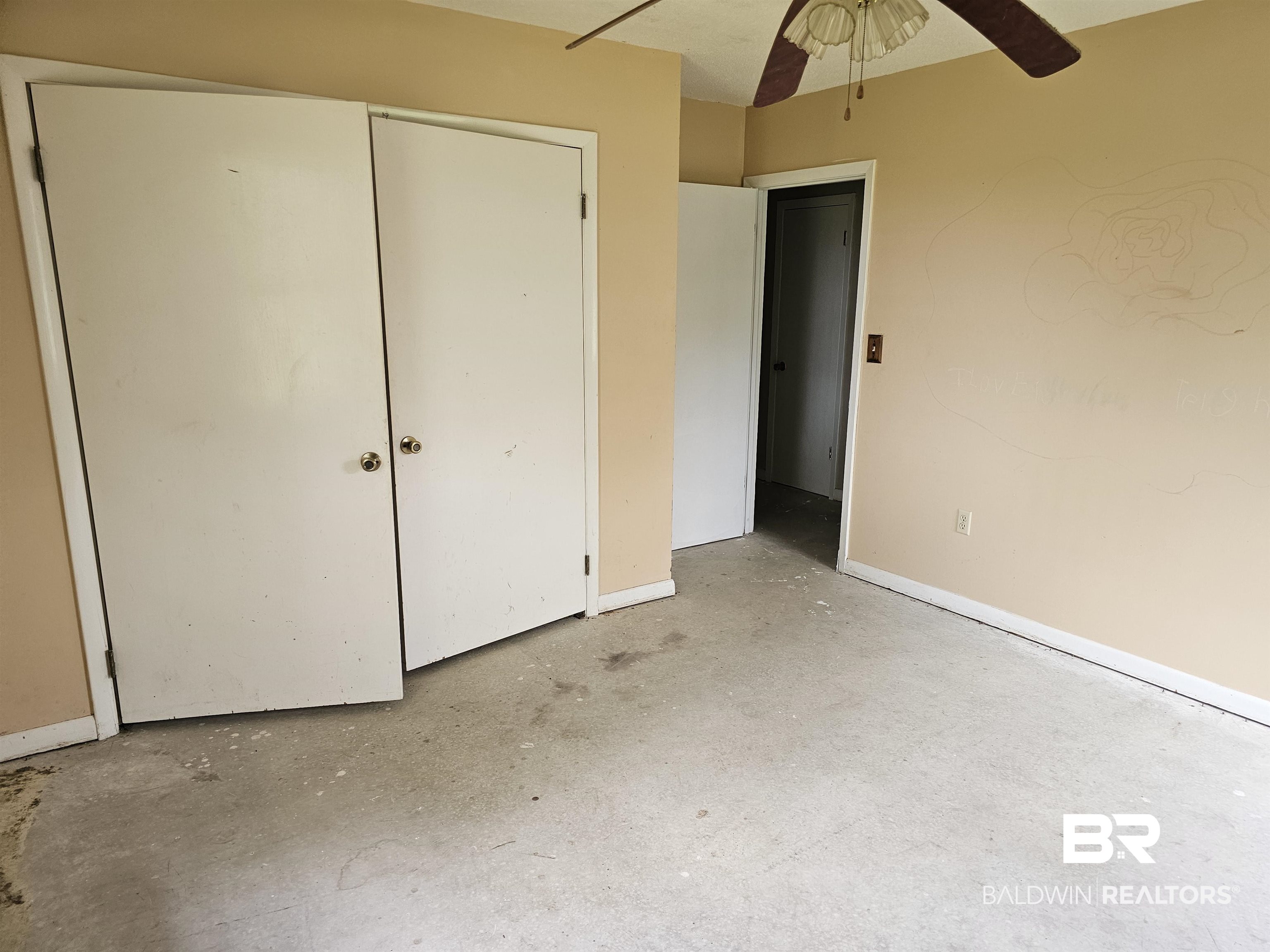 59575 Lottie Road Atmore, AL 36502 - Photo 19 of 23 Unfurnished bedroom with unfinished concrete floors, ceiling fan, baseboards, and a closet