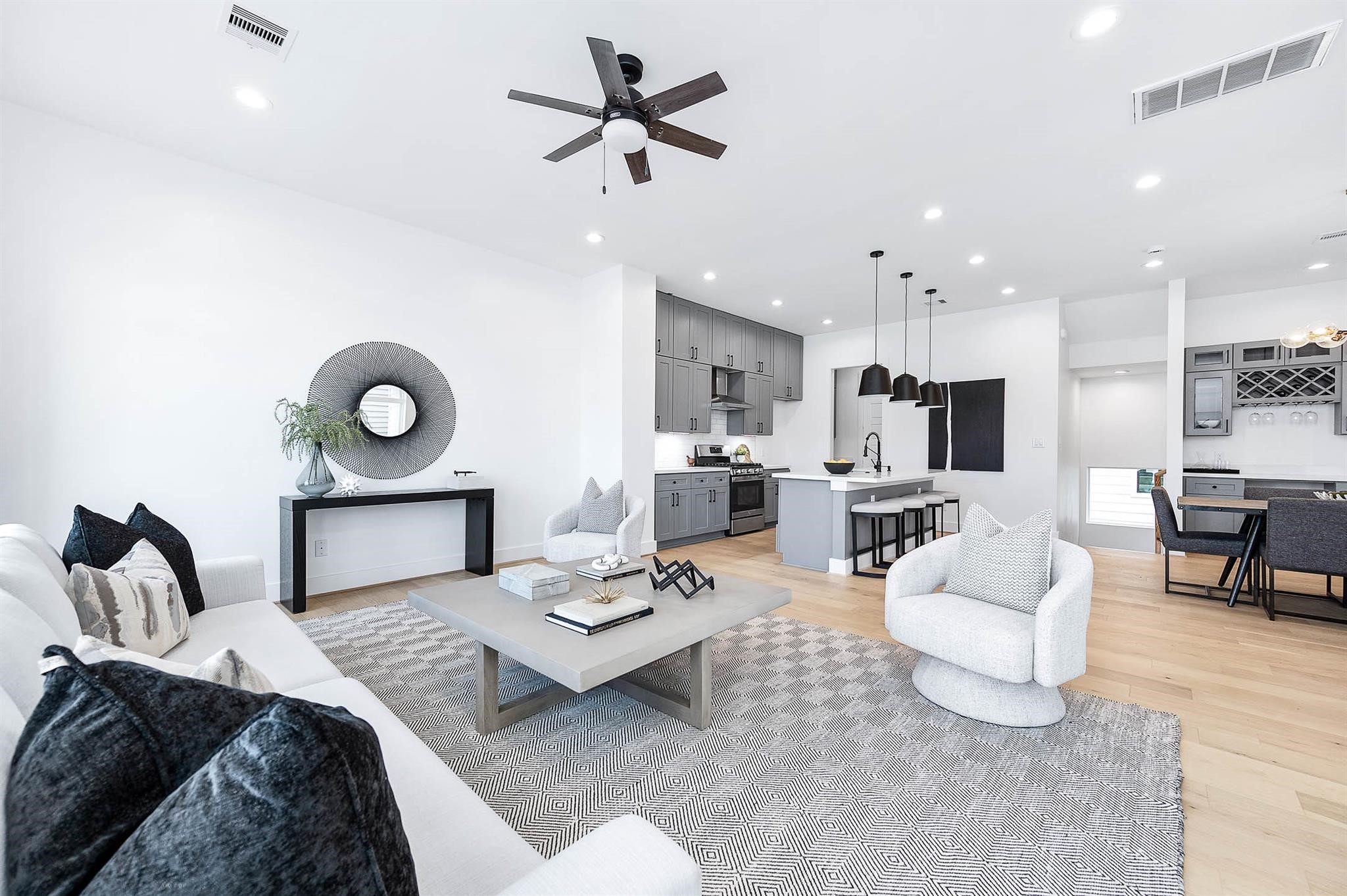 3810 Jefferson Street Houston, TX 77003 - Photo 5 of 12 a living room with furniture kitchen view and a chandelier