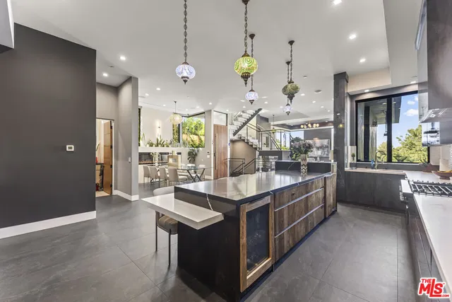 a bedroom with a large bed a flat screen tv and a large window