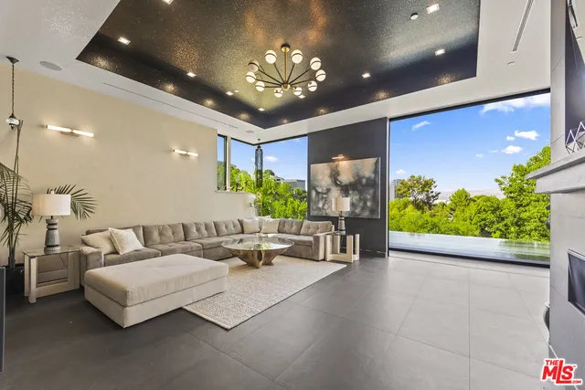 a kitchen with stainless steel appliances kitchen island granite countertop a refrigerator and a sink