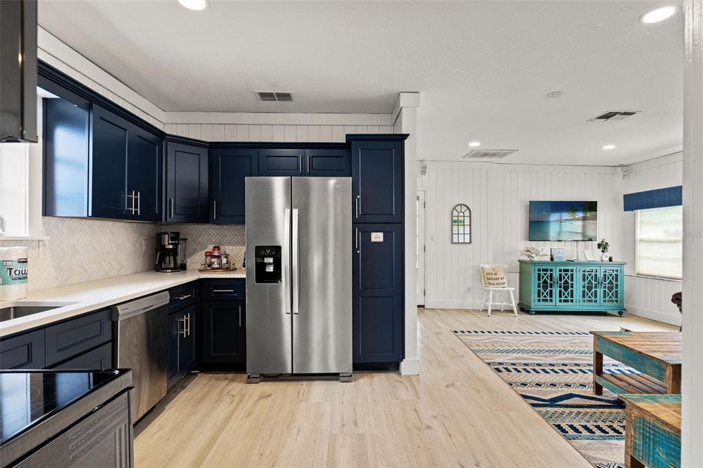 5430 Circle Drive Weeki Wachee, FL 34607 - Photo 5 of 31 a kitchen with stainless steel appliances granite countertop a refrigerator a sink and wooden cabinets