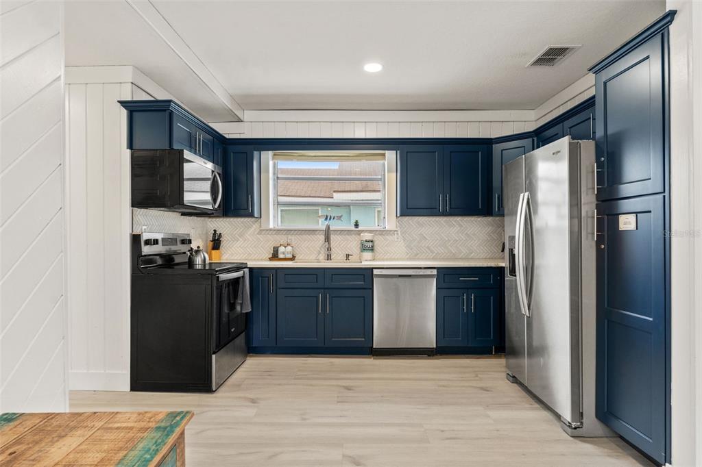 5430 Circle Drive Weeki Wachee, FL 34607 - Photo 6 of 31 a kitchen with a refrigerator and a sink