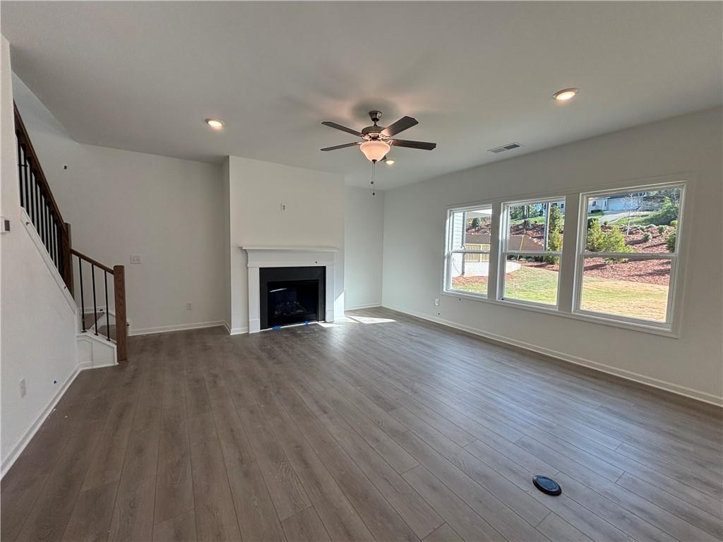 6125 Kismet Road Buford, GA 30518 - Photo 14 of 40 wooden floor in an empty room with a window