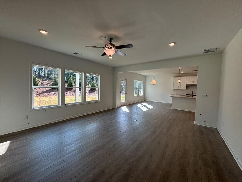 6125 Kismet Road Buford, GA 30518 - Photo 15 of 40 a view of an empty room with a window and wooden floor