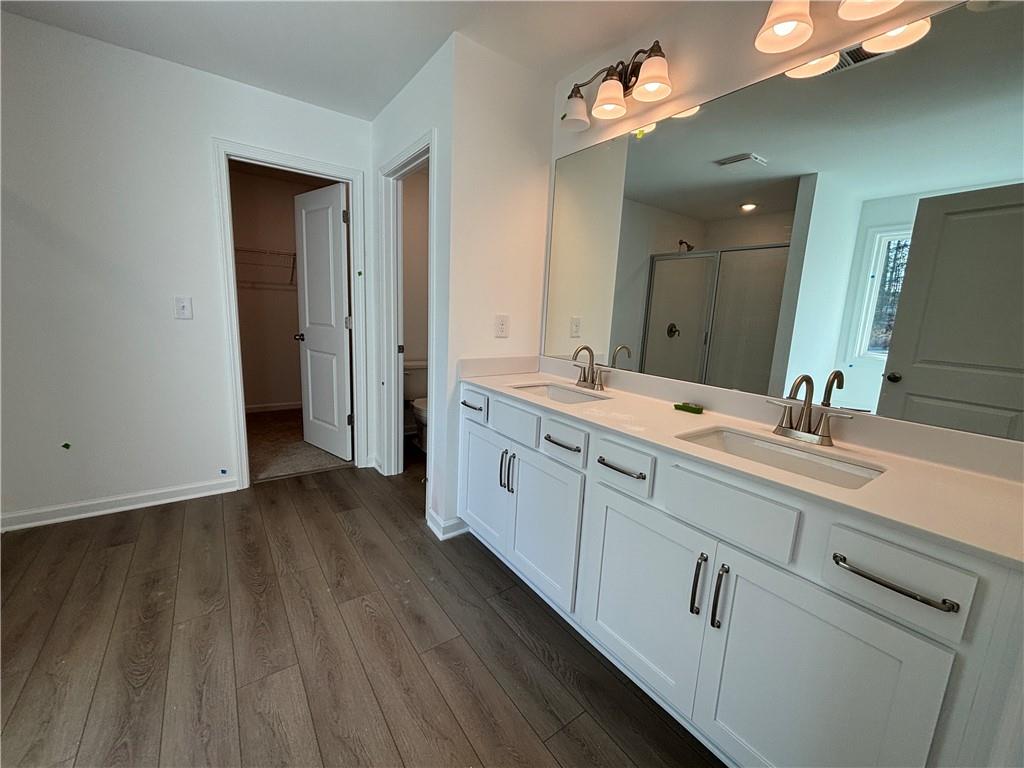 6125 Kismet Road Buford, GA 30518 - Photo 20 of 40 a spacious bathroom with double vanity and a mirror