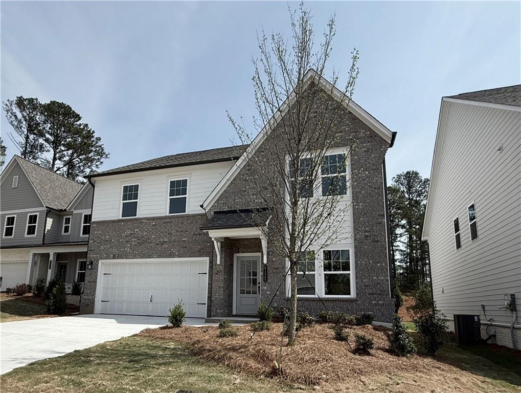 6125 Kismet Road Buford, GA 30518 - Photo 2 of 40 a front view of a house with garage