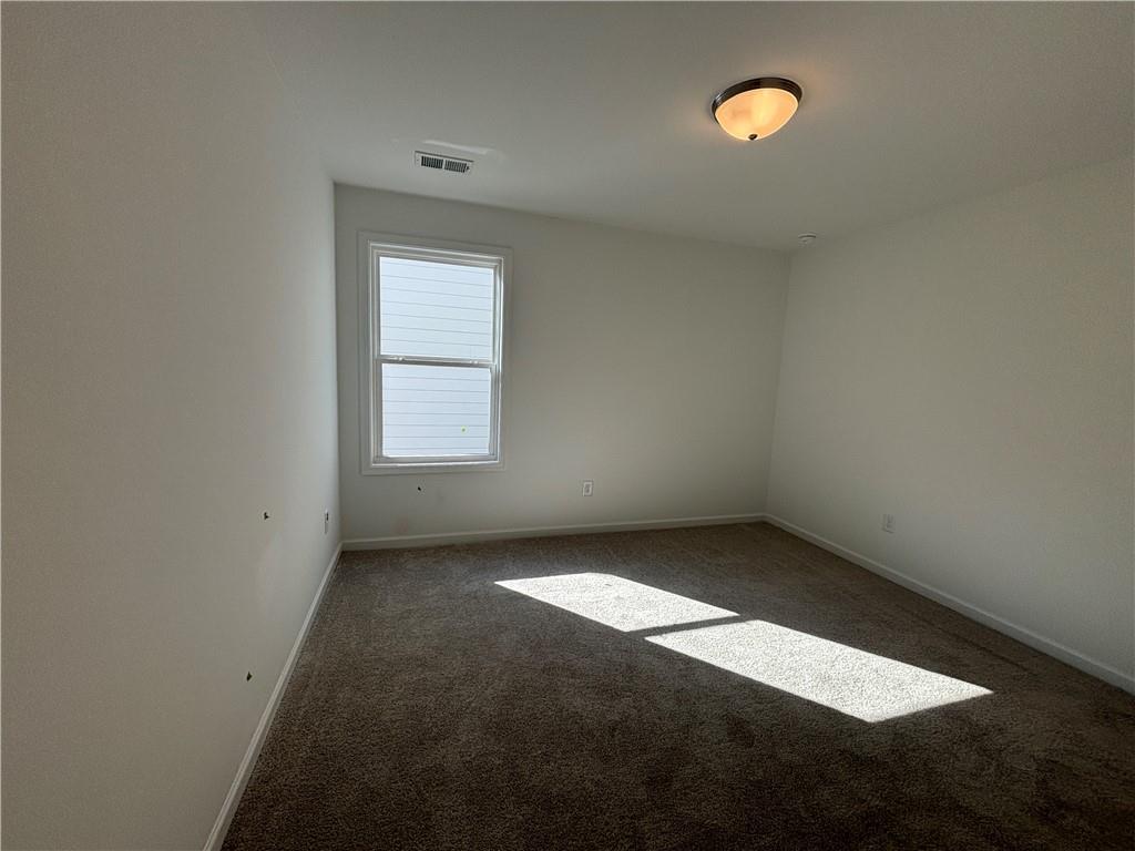 6125 Kismet Road Buford, GA 30518 - Photo 34 of 40 an empty room with a empty space and a window