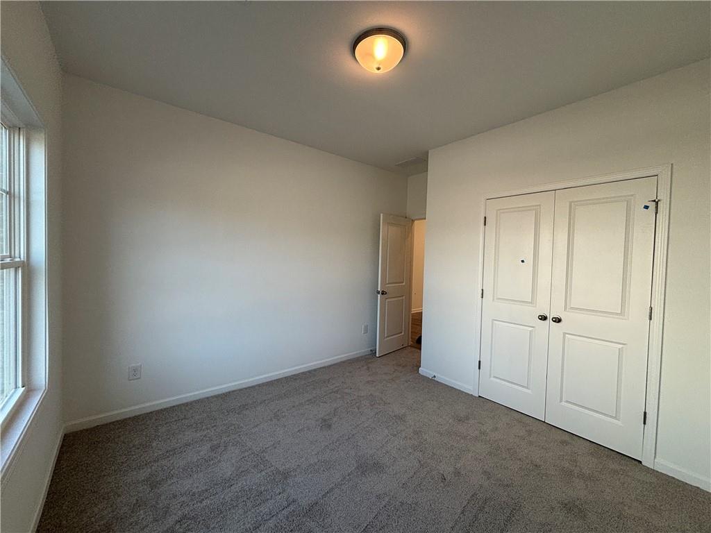 6125 Kismet Road Buford, GA 30518 - Photo 6 of 40 an empty room with windows and closet