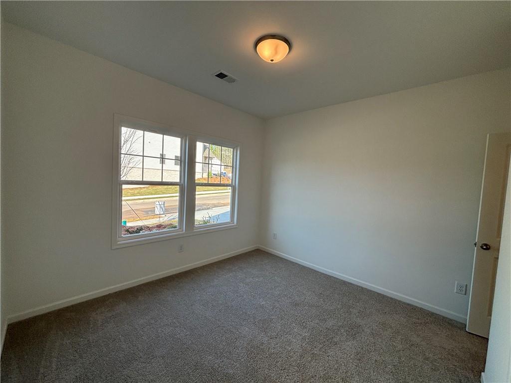 6125 Kismet Road Buford, GA 30518 - Photo 7 of 40 an empty room with a window