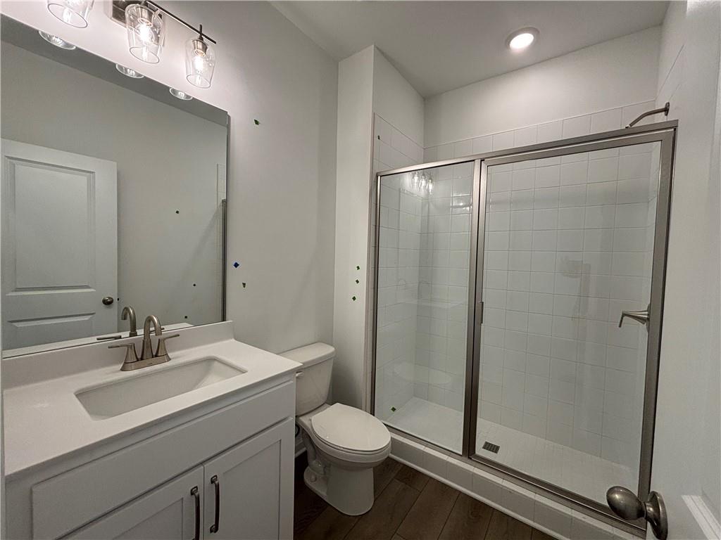 6125 Kismet Road Buford, GA 30518 - Photo 8 of 40 a bathroom with a shower sink vanity mirror and toilet