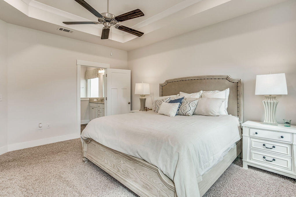 704 Quintana Street Crestview, FL 32539 - Photo 12 of 32 a bedroom with a bed and a night stand