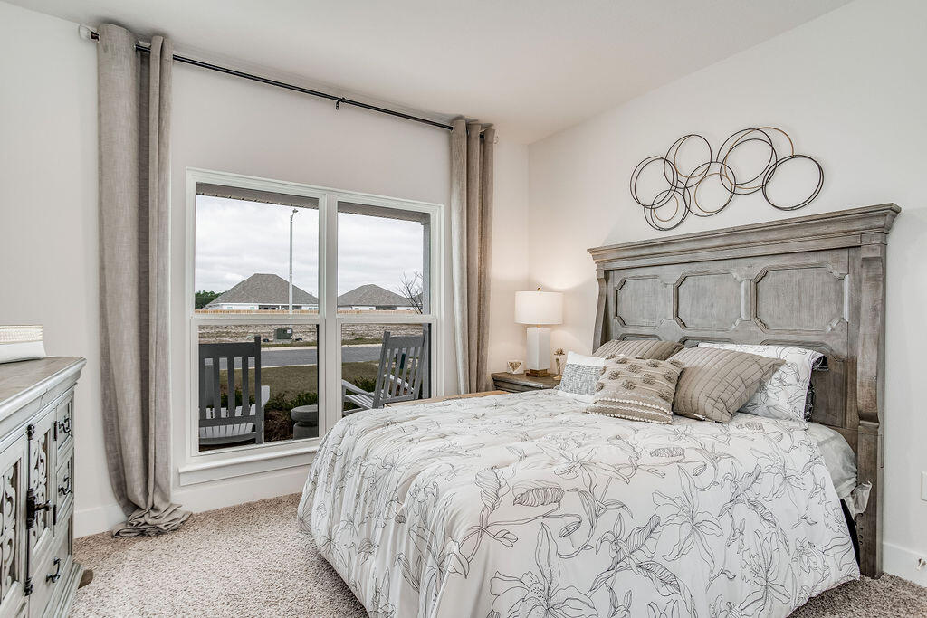 704 Quintana Street Crestview, FL 32539 - Photo 20 of 32 a bedroom with a large bed and a window