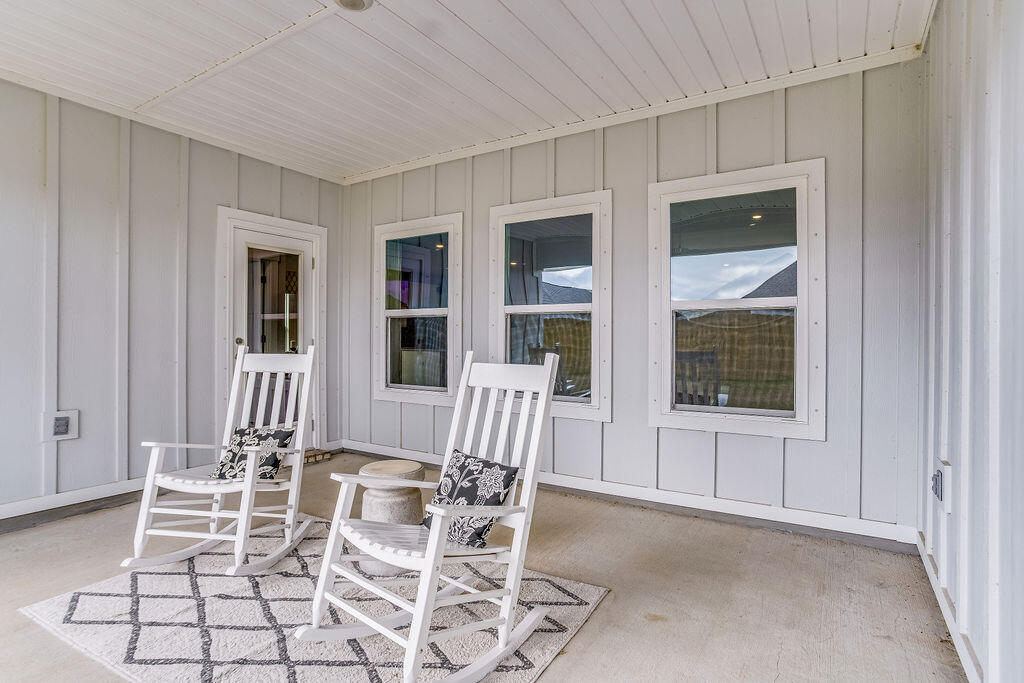704 Quintana Street Crestview, FL 32539 - Photo 23 of 32 a view of an empty room with wooden floor and windows