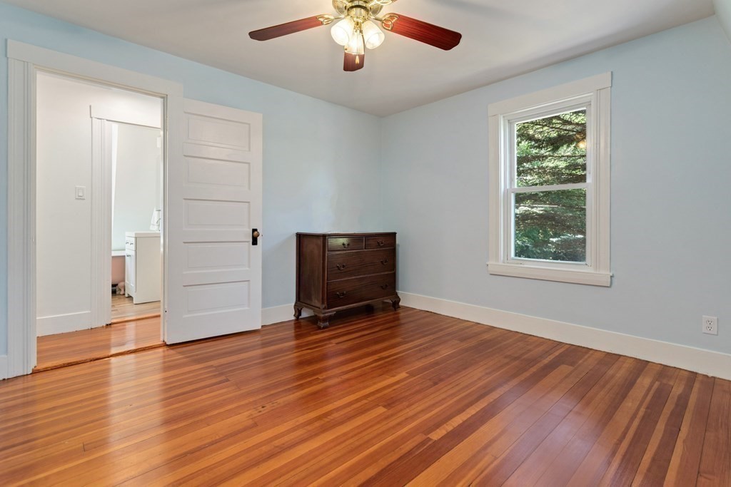 34 Eustis Street Saugus, MA 01906 - Photo 15 of 28 a view of an empty room with wooden floor and a window